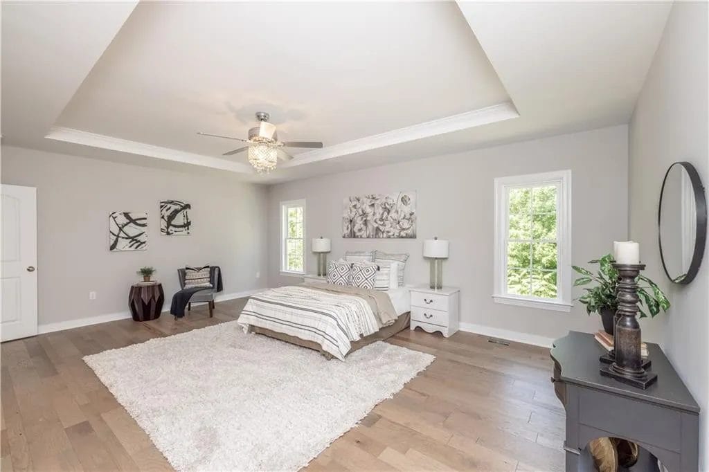 bedroom with tiered ceiling