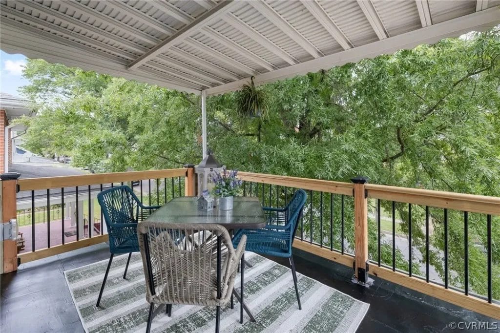 Second floor porch with table and chairs