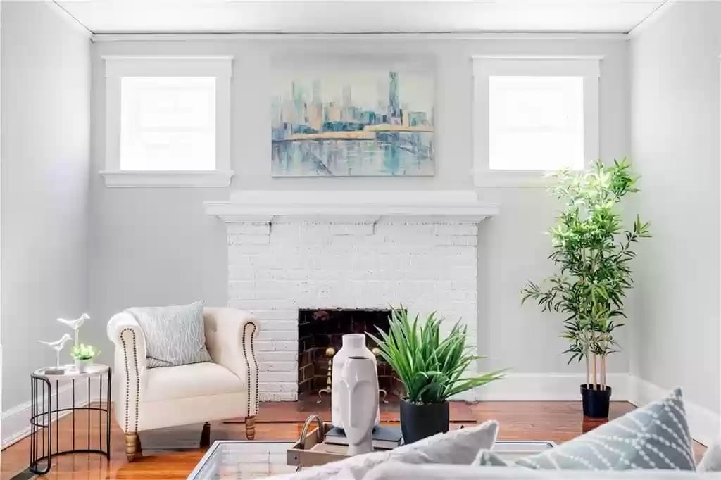 living room with fireplace and a white arm chair